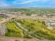 Breathtaking aerial view of a vibrant cityscape with lush green parks, a winding river, and mountain views at 2955 Inca St # 2Q, Denver, CO 80202