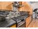 Close up of a kitchen with modern stainless steel appliances and a decorative backsplash at 2955 Inca St # 2Q, Denver, CO 80202