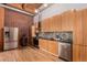 Modern kitchen with stainless steel appliances, wooden cabinets, and brick accents at 2955 Inca St # 2Q, Denver, CO 80202