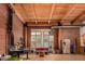 Bright open living area with exposed brick, wood ceilings, and large windows at 2955 Inca St # 2Q, Denver, CO 80202