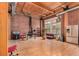 Spacious living area with brick accents, wood ceilings, and stainless steel kitchen appliances at 2955 Inca St # 2Q, Denver, CO 80202