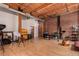 Bright open living area with exposed brick, wood ceilings, and office space at 2955 Inca St # 2Q, Denver, CO 80202