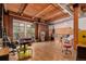 Spacious living room featuring exposed brick walls, wood ceilings, and modern kitchen amenities at 2955 Inca St # 2Q, Denver, CO 80202
