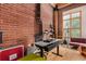 Living room featuring exposed brick walls, hardwood floors, and a dedicated workspace at 2955 Inca St # 2Q, Denver, CO 80202
