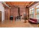 Bright open living area with exposed brick, wood ceilings, and large windows allowing ample natural light at 2955 Inca St # 2Q, Denver, CO 80202