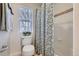 Bathroom featuring a toilet, shower/tub combo, and a window with natural light at 10148 E 29Th Dr, Denver, CO 80238