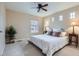 Bedroom with neutral walls, ceiling fan, windows, and a floral comforter on the bed at 10148 E 29Th Dr, Denver, CO 80238