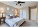 Bedroom with neutral walls, ceiling fan, windows, carpet flooring, and closet at 10148 E 29Th Dr, Denver, CO 80238