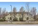 Charming townhouse showcasing its neutral color and detailed architecture surrounded by manicured landscaping at 10148 E 29Th Dr, Denver, CO 80238