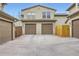 Townhome exterior featuring two-car garage, individual unit numbers, and a cozy gated yard at 10148 E 29Th Dr, Denver, CO 80238