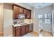 Kitchen area features wood cabinets, stainless steel appliances, and backyard access at 10148 E 29Th Dr, Denver, CO 80238