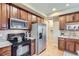 Updated kitchen features stainless steel appliances, wood cabinets and tiled backsplash at 10148 E 29Th Dr, Denver, CO 80238