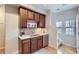 A well-lit kitchen area features wood cabinets, backsplash, and a double sink at 10148 E 29Th Dr, Denver, CO 80238