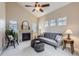 Bright living room boasts a fireplace, vaulted ceiling, neutral tones and a ceiling fan at 10148 E 29Th Dr, Denver, CO 80238