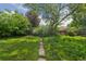 View of the lush green backyard with mature trees and landscaping at 1742 S Forest St, Denver, CO 80222