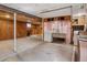 View of unfinished basement with laundry hookups, wooden accents, and drop ceiling at 1742 S Forest St, Denver, CO 80222