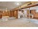 Unfinished basement featuring laundry area, wood paneling, and overhead lighting at 1742 S Forest St, Denver, CO 80222