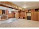 Basement with wood paneling, beige carpet, and built-in storage at 1742 S Forest St, Denver, CO 80222