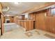 Basement area with decorative tiled floor, wood paneled walls, and built-in bar area at 1742 S Forest St, Denver, CO 80222