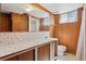 Bathroom with vanity, sink, toilet and shower/tub combo with paneled walls at 1742 S Forest St, Denver, CO 80222