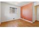 Bedroom with hardwood floors and salmon-colored wall at 1742 S Forest St, Denver, CO 80222