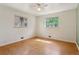 Spacious bedroom with hardwood floors, two windows, and ceiling fan at 1742 S Forest St, Denver, CO 80222