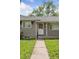 Close-up view of the home's entrance with a white door and tidy landscaping at 1742 S Forest St, Denver, CO 80222