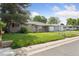 A well-kept single-story home featuring a lush green lawn and mature trees in a friendly neighborhood at 1742 S Forest St, Denver, CO 80222