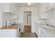 Traditional kitchen with white cabinets and neutral tile flooring at 1742 S Forest St, Denver, CO 80222