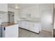 Traditional kitchen with white cabinets and a neutral countertop at 1742 S Forest St, Denver, CO 80222