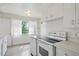 Sunlit kitchen area with white cabinets and a classic range at 1742 S Forest St, Denver, CO 80222