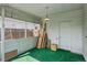 Enclosed sunroom/porch with green carpet and view to the backyard at 1742 S Forest St, Denver, CO 80222