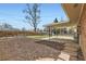 Fenced backyard with mature trees, covered patio and stone pavers at 2822 S Zenobia St, Denver, CO 80236