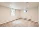 This carpeted basement room features bright recessed lights and multiple windows that provide natural light at 2822 S Zenobia St, Denver, CO 80236