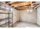 Utility basement area with exposed ceiling, concrete walls, and shelving at 2822 S Zenobia St, Denver, CO 80236