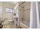 Nicely updated bathroom with modern tiles, pedestal sink, and a shower-tub combination at 2822 S Zenobia St, Denver, CO 80236