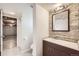 Basement bathroom features a tiled floor, shower, toilet, vanity, and mirror for convenience at 2822 S Zenobia St, Denver, CO 80236