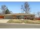 Charming single-story home with a brick facade, attached garage, and well-maintained front yard at 2822 S Zenobia St, Denver, CO 80236