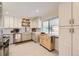 Bright kitchen featuring white cabinets, stainless steel appliances, and a butcher block island at 2822 S Zenobia St, Denver, CO 80236