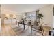 Inviting living room with large windows, hardwood floors, and stylish furnishings at 2822 S Zenobia St, Denver, CO 80236