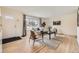 Inviting living room with large window, hardwood floors, and neutral decor at 2822 S Zenobia St, Denver, CO 80236