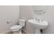 Bathroom features a white toilet, pedestal sink, mirror, and chrome fixtures at 30 Garfield St # G, Denver, CO 80206