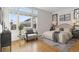 Bright bedroom featuring large windows, a decorative accent wall, and hardwood floors at 30 Garfield St # G, Denver, CO 80206