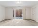 Neutral carpeted bedroom with a large sliding glass door, white walls, and trim at 30 Garfield St # G, Denver, CO 80206