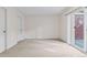 Clean bedroom with neutral carpet, two closets, and glass sliding doors to patio at 30 Garfield St # G, Denver, CO 80206