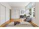 Bright bedroom featuring large windows, closet, hardwood floors, and dresser at 30 Garfield St # G, Denver, CO 80206