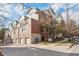 Beautiful townhome boasts brick and stone facade, attached garages, and manicured landscaping for attractive curb appeal at 30 Garfield St # G, Denver, CO 80206