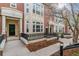 Charming townhome exterior with brick accents, a landscaped entrance, and a black front door at 30 Garfield St # G, Denver, CO 80206