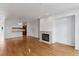 Bright living room with hardwood floors, fireplace, and partial view into kitchen at 30 Garfield St # G, Denver, CO 80206