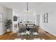 Open concept living room featuring a dining area and a sitting area with a fireplace and large windows at 30 Garfield St # G, Denver, CO 80206